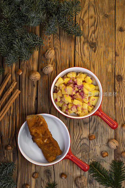 A traditional Christmas dinner in the Czech Republic - sliced carp with potato salad